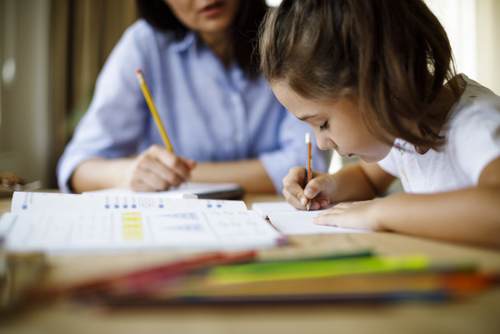 Mother helping daughter with homework