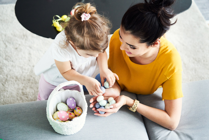 Young mother preparing Easter decorations with her daughter