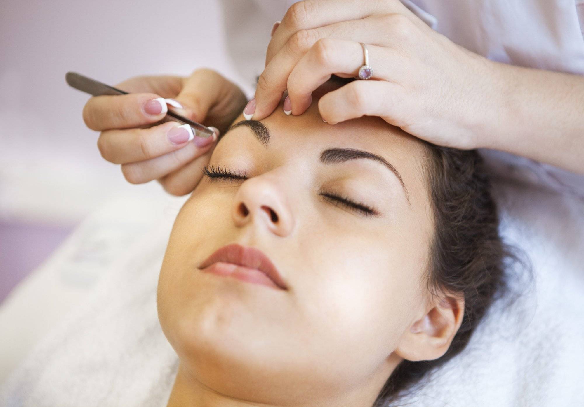 Beautiful young woman in cosmetic salon